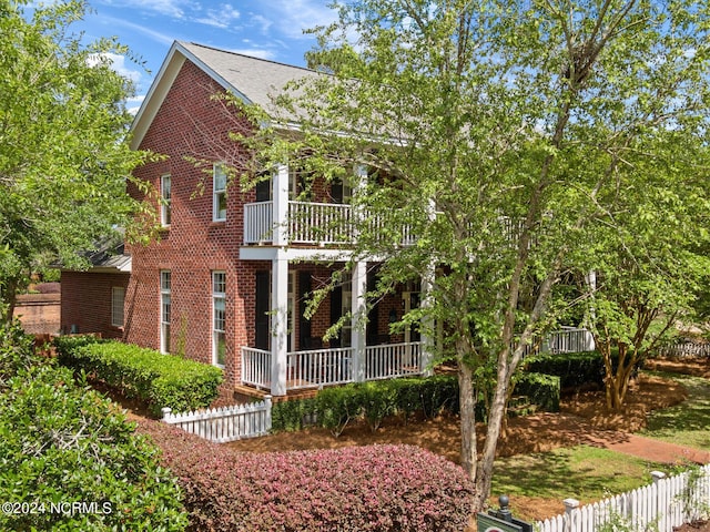 6920 Runningbrook Ter, Wilmington, NC 28411 - view of front facade with brick siding, a balcony, and fence
