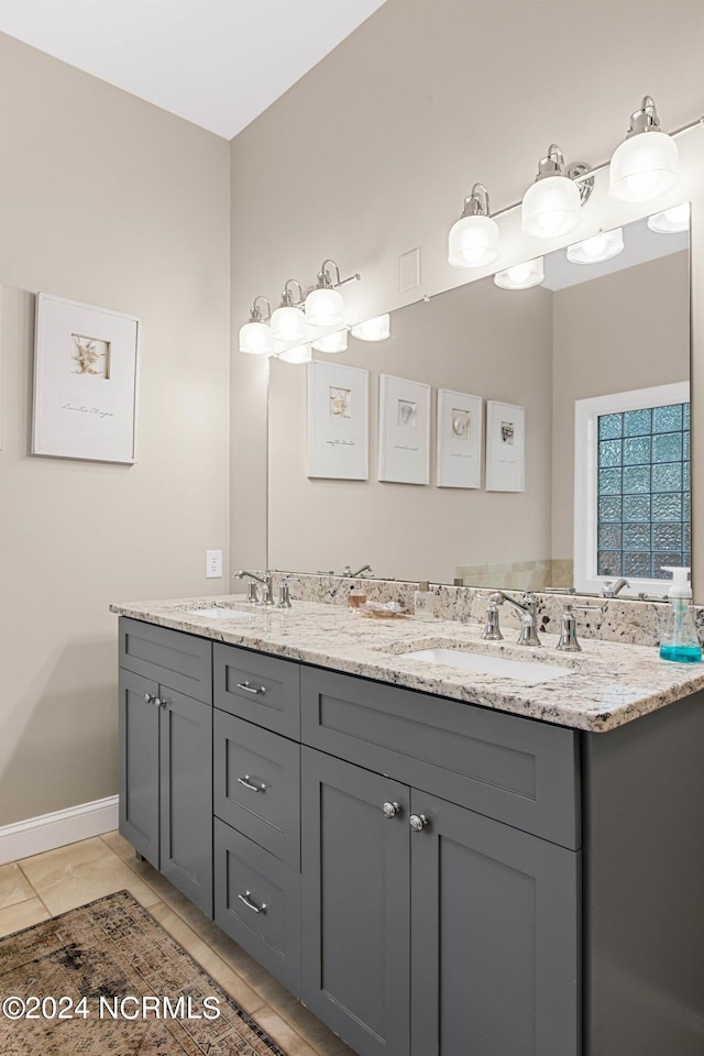 6920 Runningbrook Ter, Wilmington, NC 28411 - full bathroom with double vanity, tile patterned floors, and baseboards