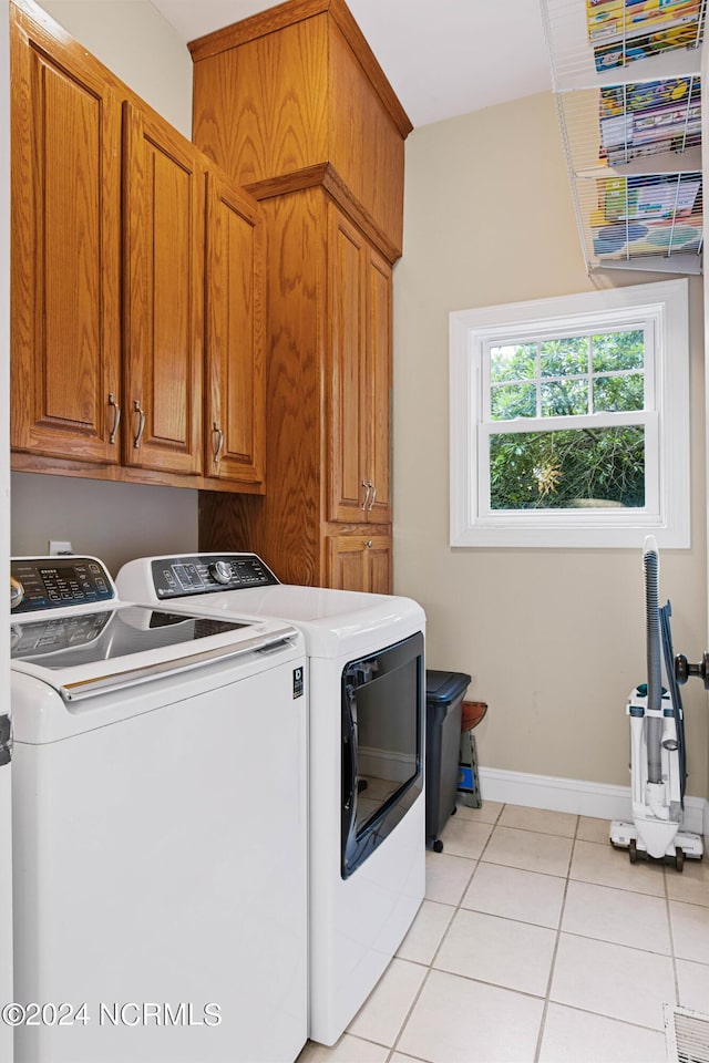 6920 Runningbrook Ter, Wilmington, NC 28411 - laundry area with washer and dryer, cabinet space, light tile patterned flooring, and baseboards