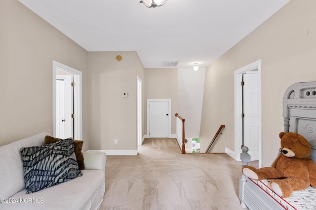 6920 Runningbrook Ter, Wilmington, NC 28411 - living area with an upstairs landing, light carpet, and baseboards
