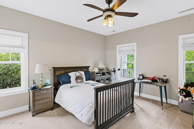 6920 Runningbrook Ter, Wilmington, NC 28411 - bedroom featuring light colored carpet, multiple windows, baseboards, and a ceiling fan
