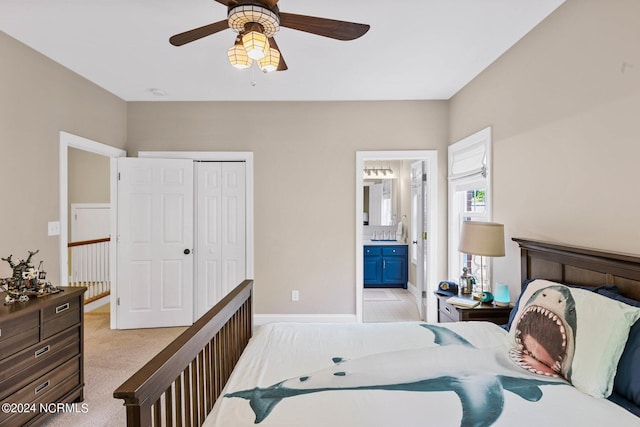 6920 Runningbrook Ter, Wilmington, NC 28411 - bedroom with light colored carpet, a closet, connected bathroom, and a ceiling fan