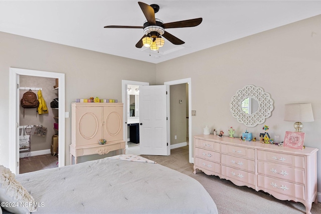 6920 Runningbrook Ter, Wilmington, NC 28411 - carpeted bedroom with a walk in closet, ensuite bathroom, a closet, and baseboards