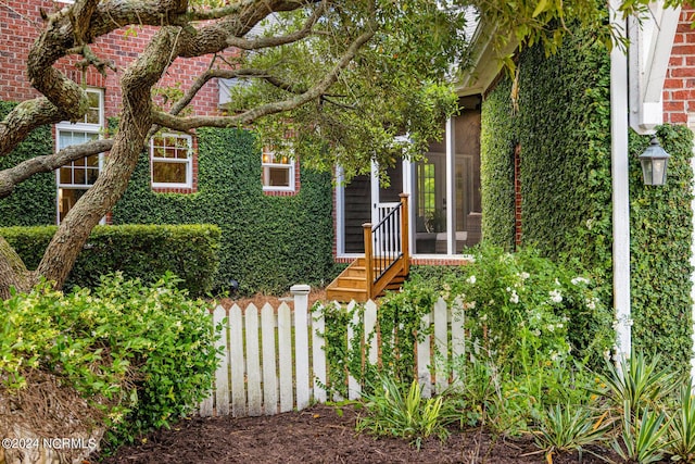 6920 Runningbrook Ter, Wilmington, NC 28411 - view of home's exterior featuring a sunroom and fence