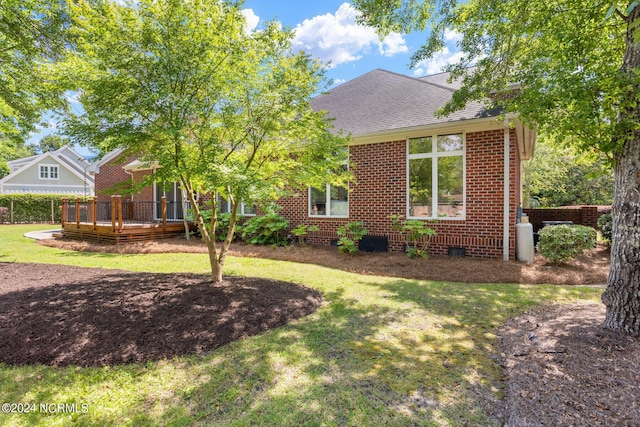 6920 Runningbrook Ter, Wilmington, NC 28411 - view of front of home featuring brick siding, a wooden deck, a front yard, and a shingled roof