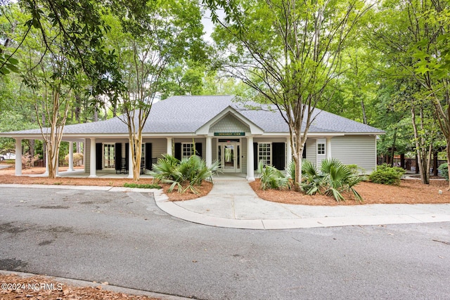 6920 Runningbrook Ter, Wilmington, NC 28411 - single story home with covered porch, roof with shingles, and french doors