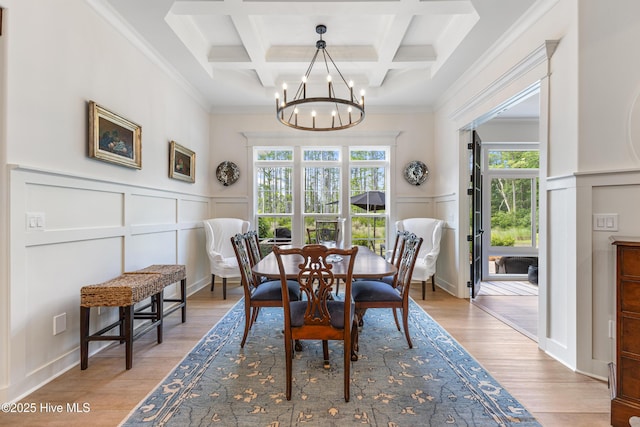 dining room with a decorative wall, a chandelier, beamed ceiling, coffered ceiling, and ornamental molding