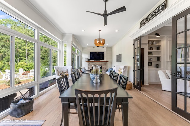 dining area with ceiling fan, crown molding, light wood-style floors, french doors, and recessed lighting