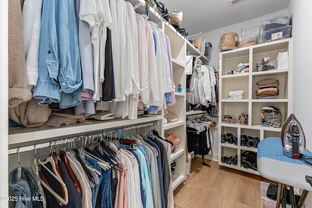 walk in closet featuring wood finished floors