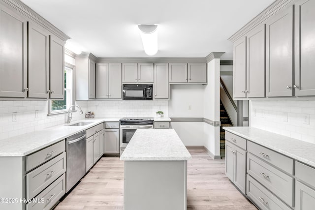 103 E Raintree Ln, Goldsboro, NC 27534 - kitchen with stainless steel appliances, gray cabinetry, a sink, and a kitchen island