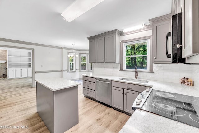 103 E Raintree Ln, Goldsboro, NC 27534 - kitchen featuring gray cabinets, a sink, appliances with stainless steel finishes, ornamental molding, and light wood-style flooring