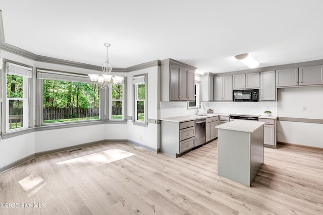 103 E Raintree Ln, Goldsboro, NC 27534 - kitchen with black microwave, dishwasher, gray cabinetry, a sink, and a chandelier
