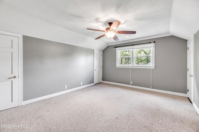 103 E Raintree Ln, Goldsboro, NC 27534 - additional living space with lofted ceiling, ceiling fan, a textured ceiling, light carpet, and baseboards