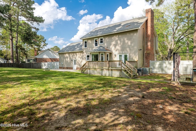 103 E Raintree Ln, Goldsboro, NC 27534 - back of property featuring central air condition unit, a chimney, a deck, and a shingled roof
