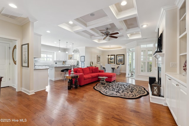 living area with crown molding, hardwood / wood-style floors, beamed ceiling, a ceiling fan, and recessed lighting
