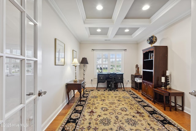 office area featuring beamed ceiling, coffered ceiling, baseboards, wood finished floors, and crown molding
