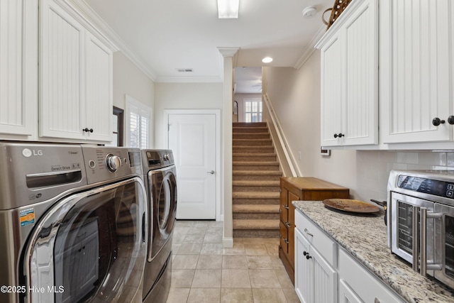 laundry area with independent washer and dryer, plenty of natural light, ornamental molding, and recessed lighting