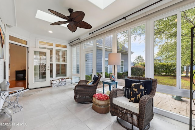 sunroom / solarium with a skylight and tile patterned floors