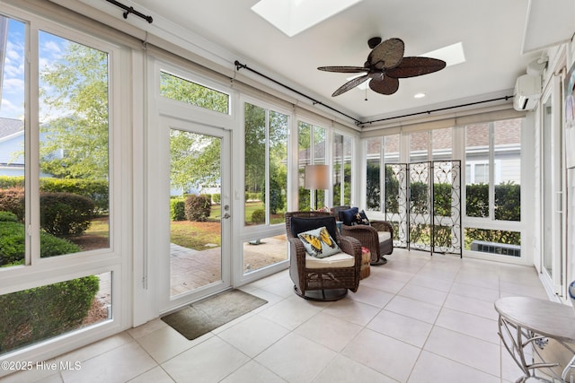 sunroom with a skylight, a ceiling fan, healthy amount of natural light, and a wall mounted air conditioner