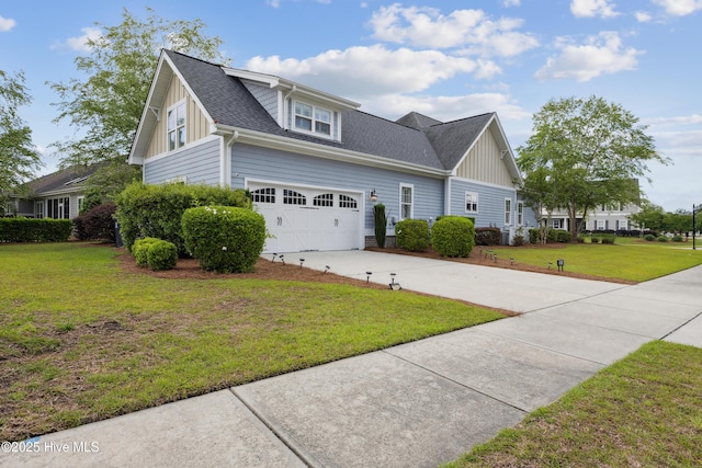 view of front of house with board and batten siding, concrete driveway, roof with shingles, a front yard, and an attached garage