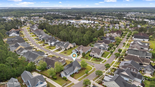 aerial overview of property's location featuring nearby suburban area and a large body of water