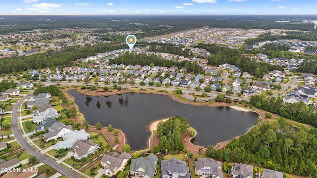 aerial overview of property's location with a nearby body of water and nearby suburban area
