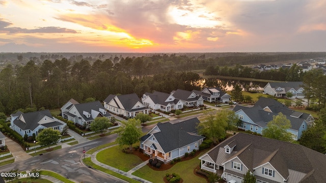 aerial view at dusk of a residential view and a forest view