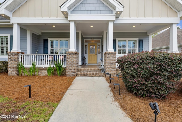 property entrance featuring board and batten siding and covered porch