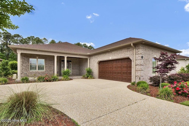 ranch-style home with an attached garage, a porch, driveway, and brick siding
