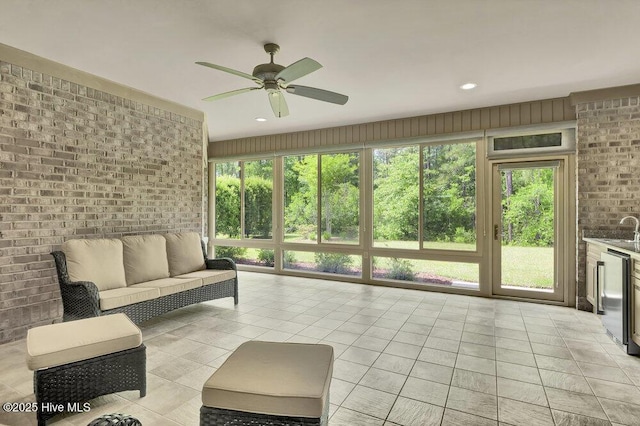 sunroom featuring ceiling fan, a sink, an outdoor hangout area, and wine cooler