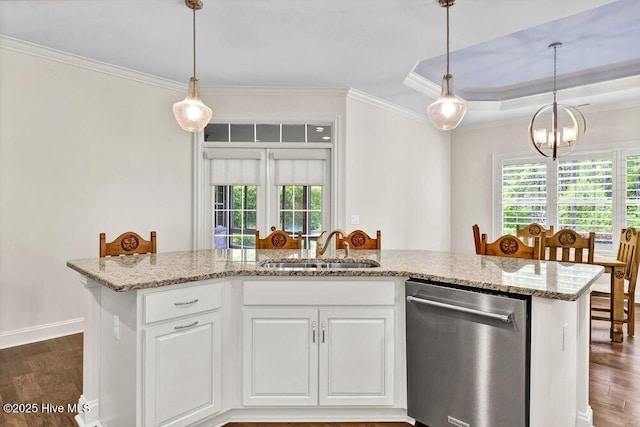 kitchen with stainless steel dishwasher, a sink, plenty of natural light, ornamental molding, and wood finished floors