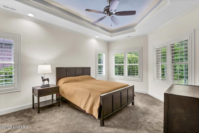 bedroom with carpet flooring, ornamental molding, baseboards, a raised ceiling, and ceiling fan