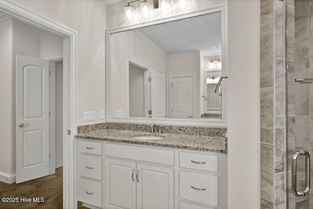 full bathroom featuring vanity and tiled shower