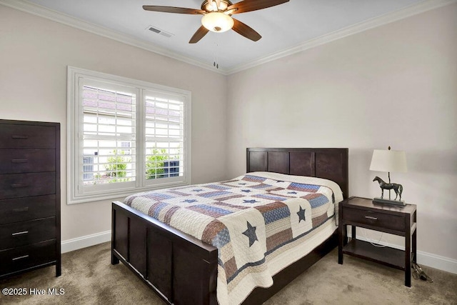 carpeted bedroom with baseboards, crown molding, and ceiling fan