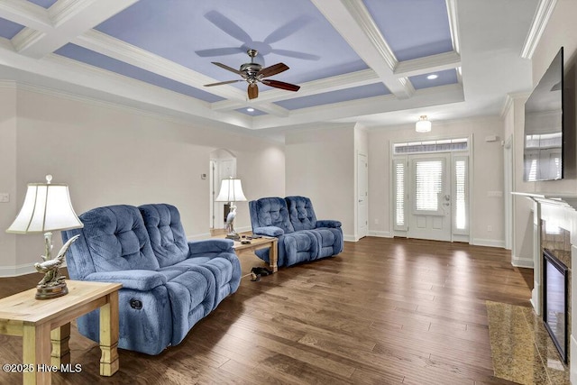 living room featuring coffered ceiling, ornamental molding, beamed ceiling, ceiling fan, and dark wood-style floors