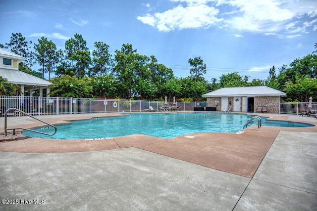 community pool with fence and a patio