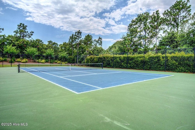 view of tennis court with fence
