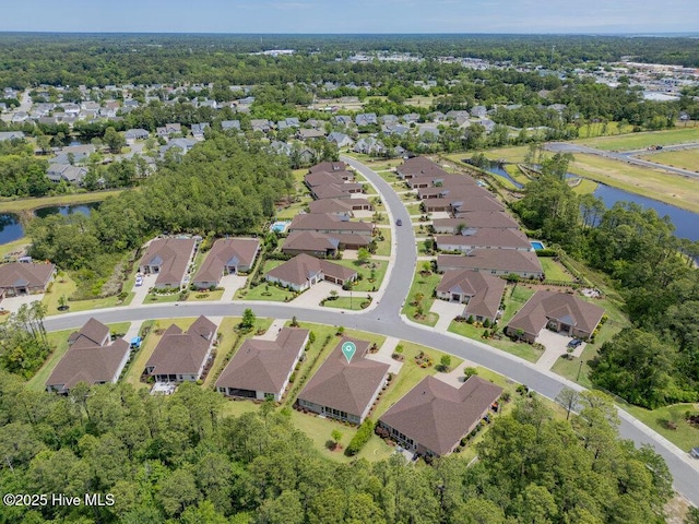 aerial overview of property's location with a nearby body of water and nearby suburban area