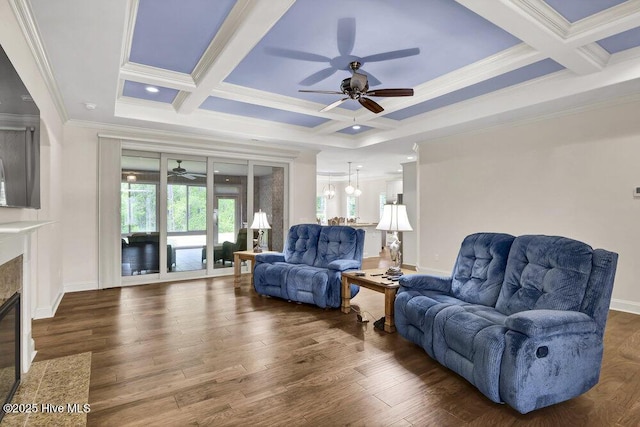 living room featuring a ceiling fan, coffered ceiling, ornamental molding, a fireplace with flush hearth, and beamed ceiling