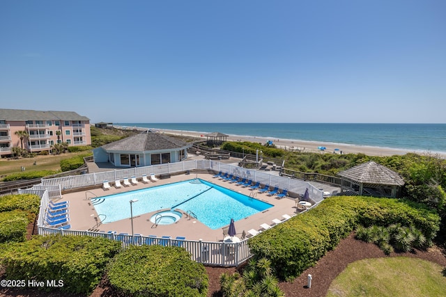 community pool featuring fence, a water view, a gazebo, and a patio area