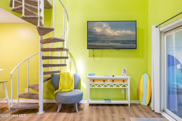 recreation room with wood finished floors and baseboards