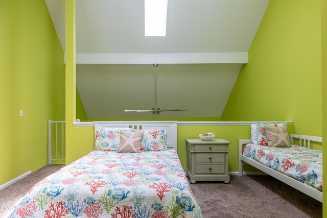 carpeted bedroom with vaulted ceiling and baseboards