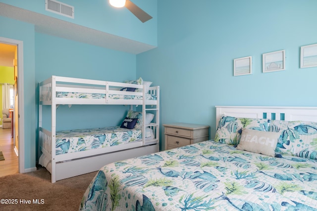 carpeted bedroom featuring ceiling fan and baseboards