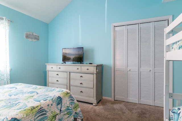 carpeted bedroom featuring lofted ceiling and a closet