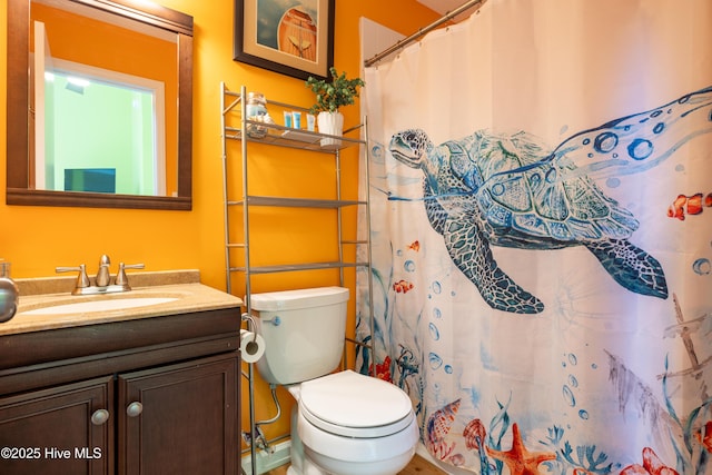 bathroom with vanity, toilet, and curtained shower