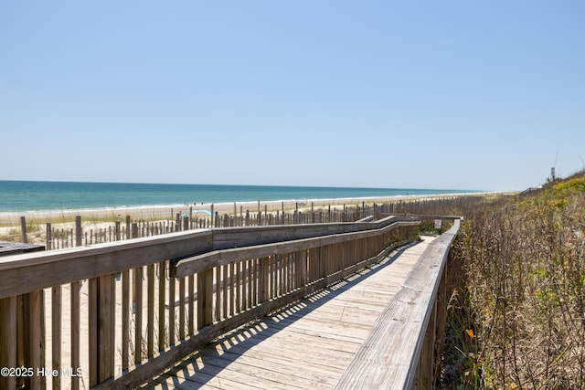 view of community with view of water and beach