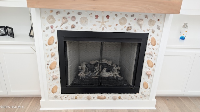 detailed view of a fireplace and wood finished floors