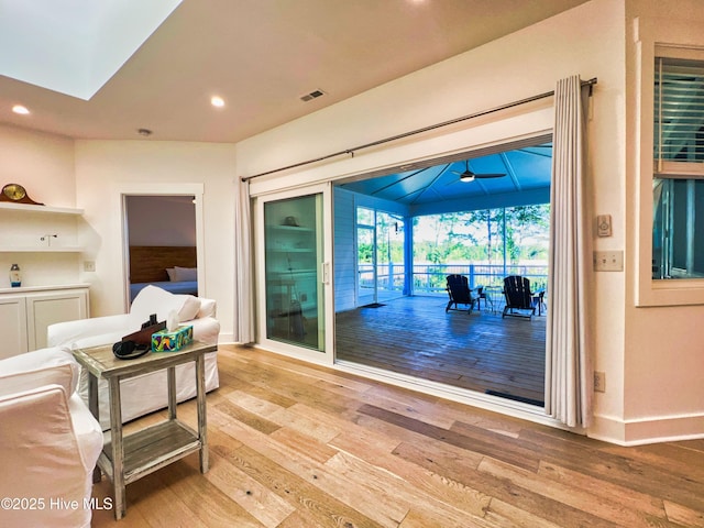 corridor featuring hardwood / wood-style floors, recessed lighting, and baseboards