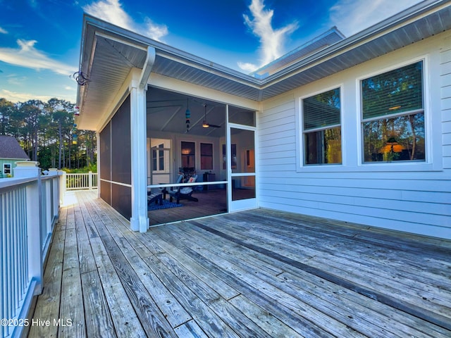 wooden deck with a sunroom