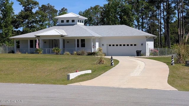 view of front of house with a garage, covered porch, and driveway